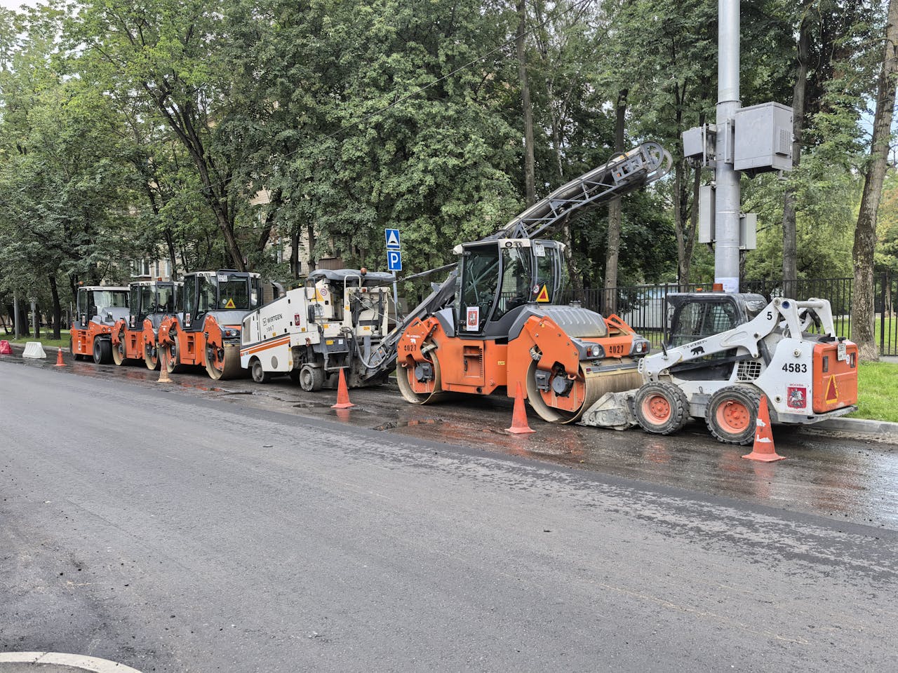 services-01 Heavy machinery lined up for road construction in a city.
